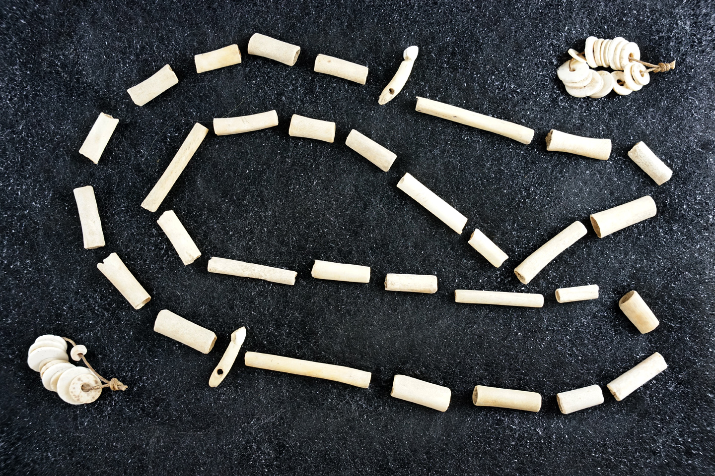 Nice set of bone tube beads, two drilled teeth and two small strands of drilled shell beads.