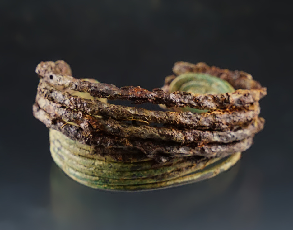 2 13/16" wide pair of wrist cuffs that have grown together while in the ground. Burrell Creek site, NY.