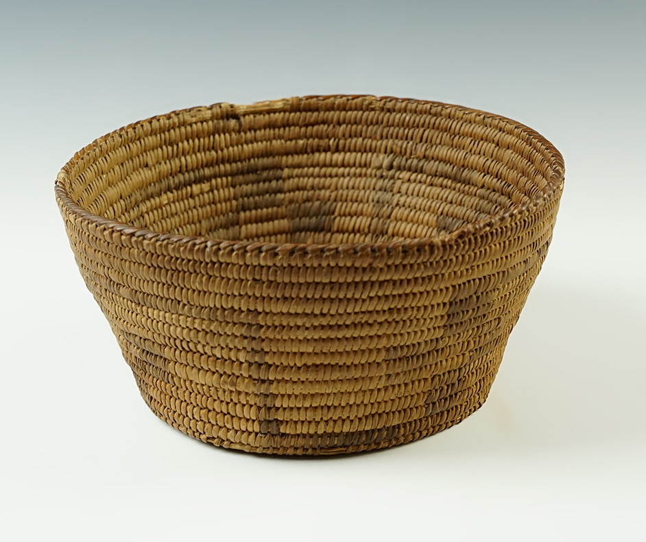 Approx. 6 3/4" diameter x 3" tall Basket that is tightly woven with geometric designs inside and out. 