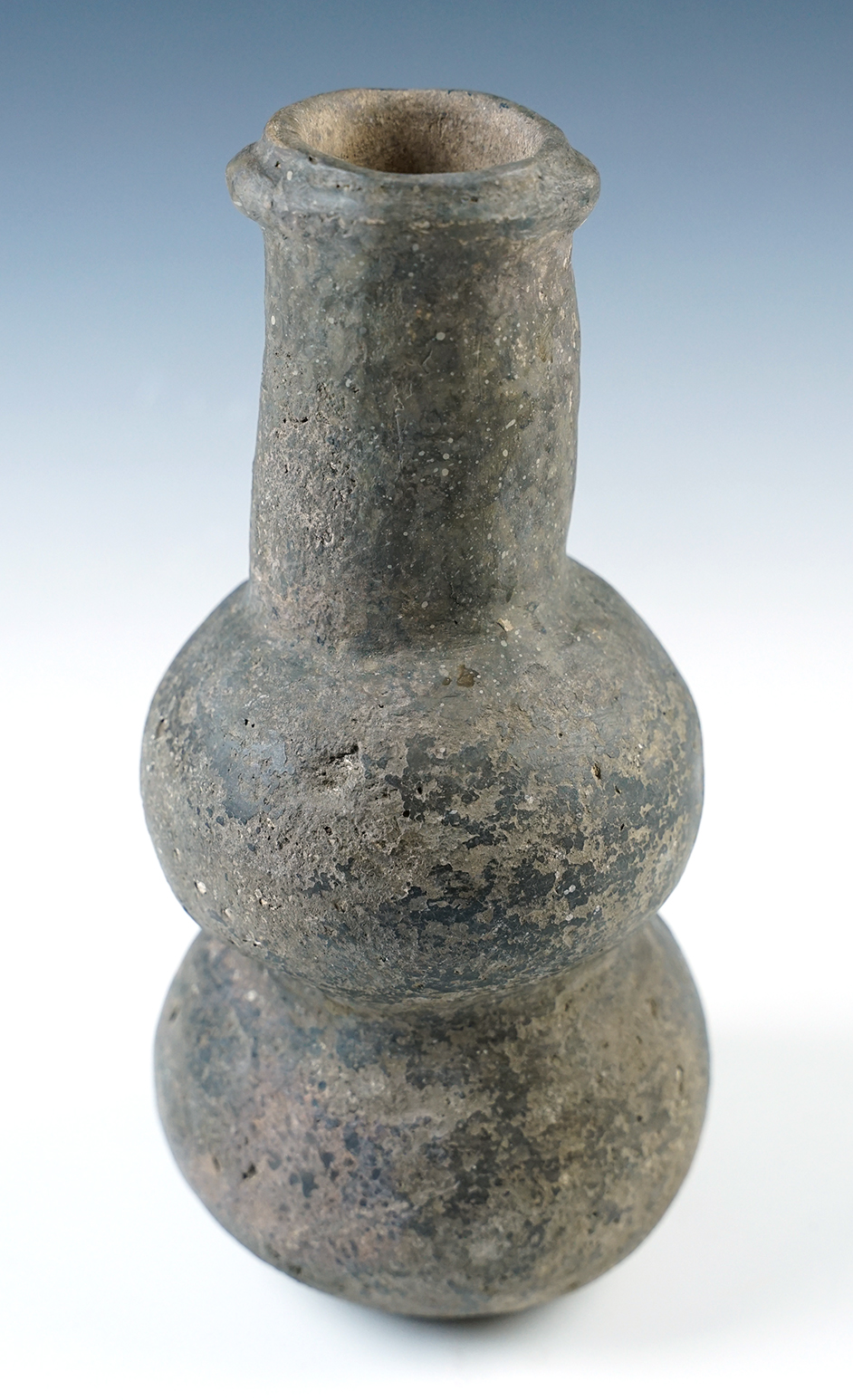 7 3/4" tall Shell tempered clay Compound Bottle with dimpled base. Found in Tiptonville, TN.