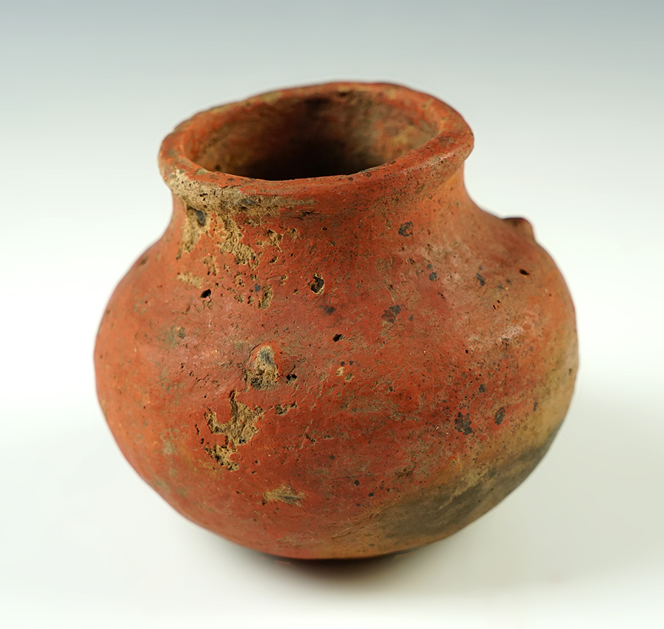 3 3/4" wide x 3 1/4" tall Mississippian Miniature Jar with three nodes on the shoulder covered in old-town red paint. Found in Cross Co., Arkansas. Ex. Roy Pohler. Pictured on page 173 of "Who's Who #6". Come with a Perino COA. 