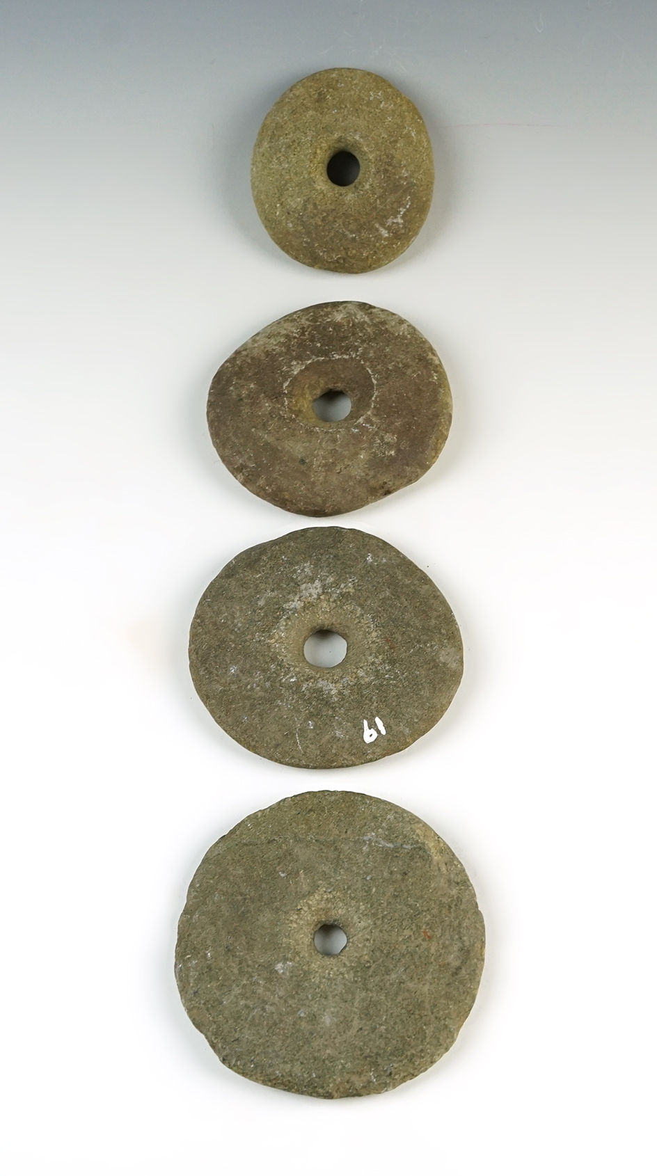 Set of four Perforated Stone Weights recovered in Colusa Co., California. Largest is 3 3/8".