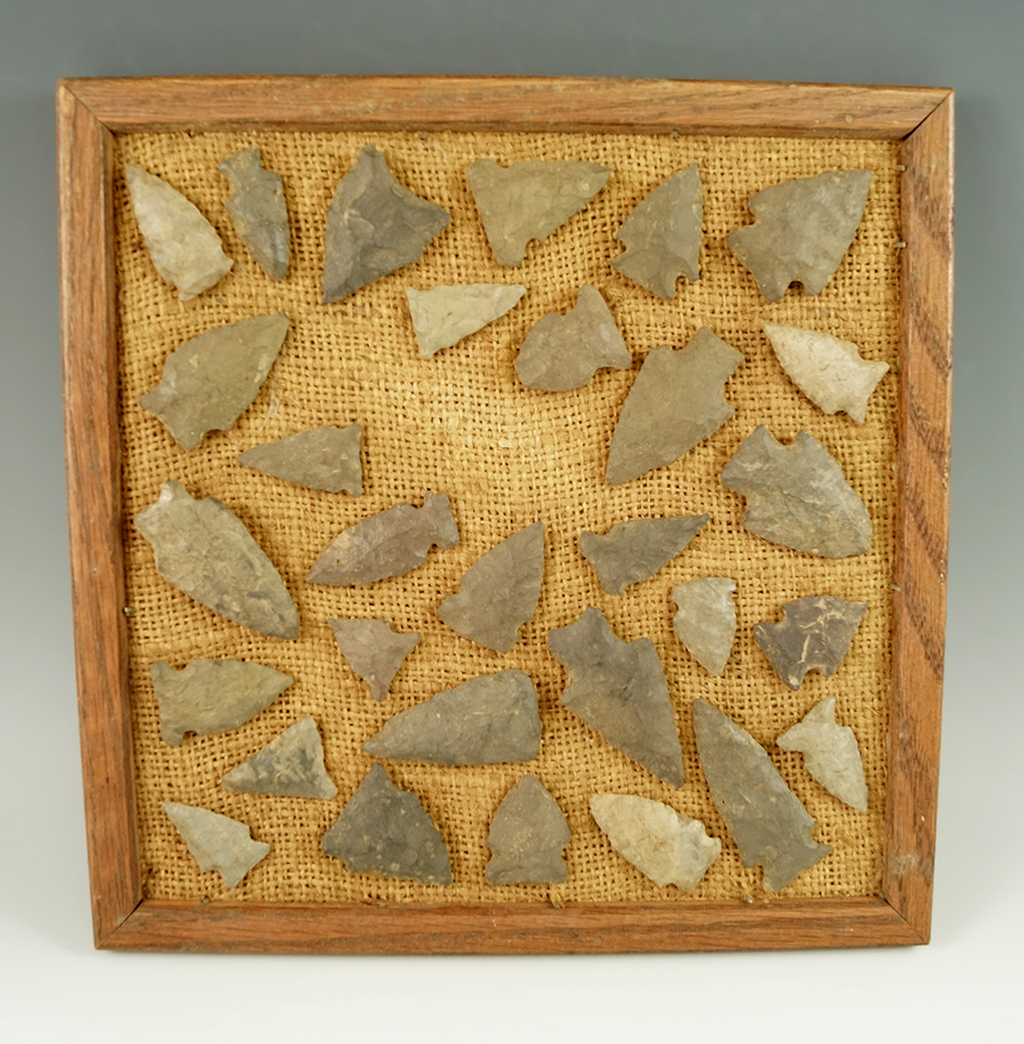 Group of approximately 30 assorted Pennsylvania arrowheads glued to a frame, largest is 2 1/8".