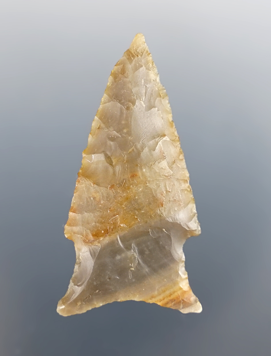 Excellent style on this 1 7/8" Stemmed Dart Point made from attractive material, found in Texas.