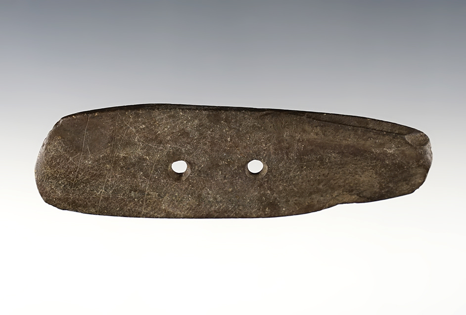 4 1/8" Gorget that is well patinated. Found in Ohio. Has several lines engraved across one face.