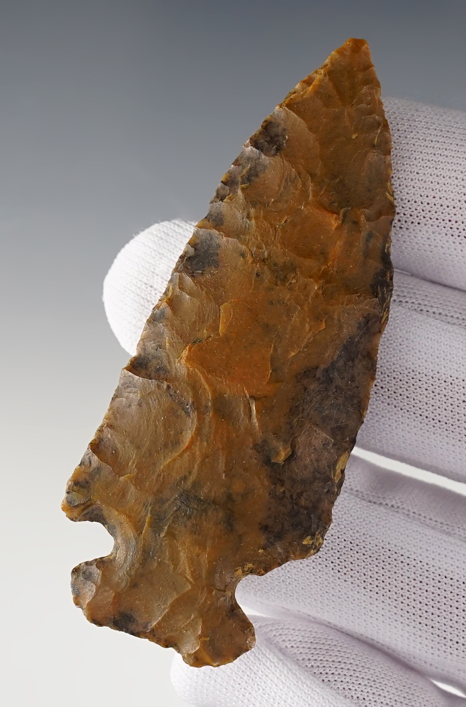 2 15/16" heavily patinated Archaic Cornernotch found in Ohio. Small ancient ding to one shoulder.