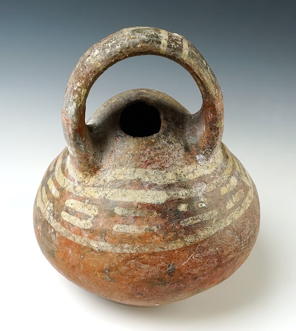Unique design on this nicely painted 6" wide x 7" tall Pre-Columbian Handled Bottle, Mesoamerica. 