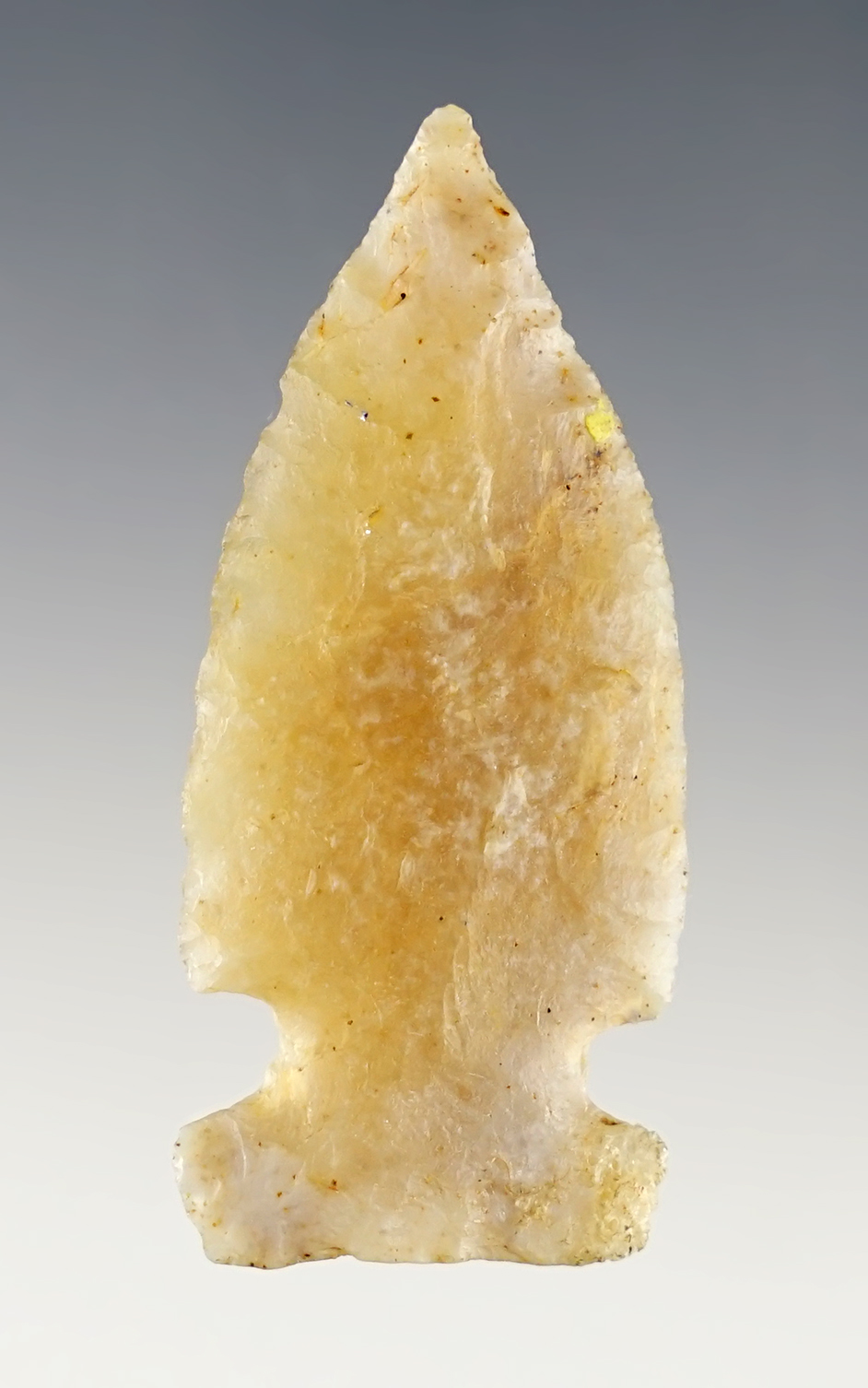 2 1/16" Archaic Sidenotch made from Quartz. One ear has been restored. Midwestern U.S.