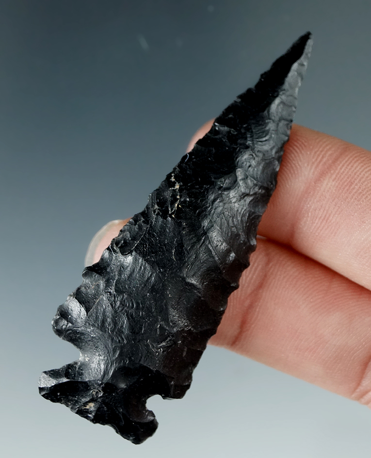 2 7/16" Cornernotch made from striped Obsidian with a curve to the blade. Found in Oregon.