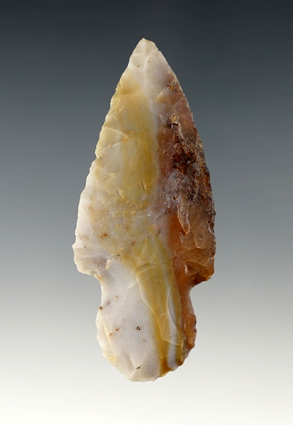 2 9/16" Adena made from grey, gold and brown Flint Ridge Flint. Found in Ohio.