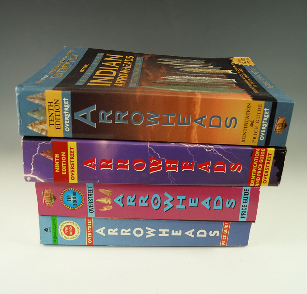 Set of four Overstreet arrowhead price guides including volumes five, seven, nine, ten.