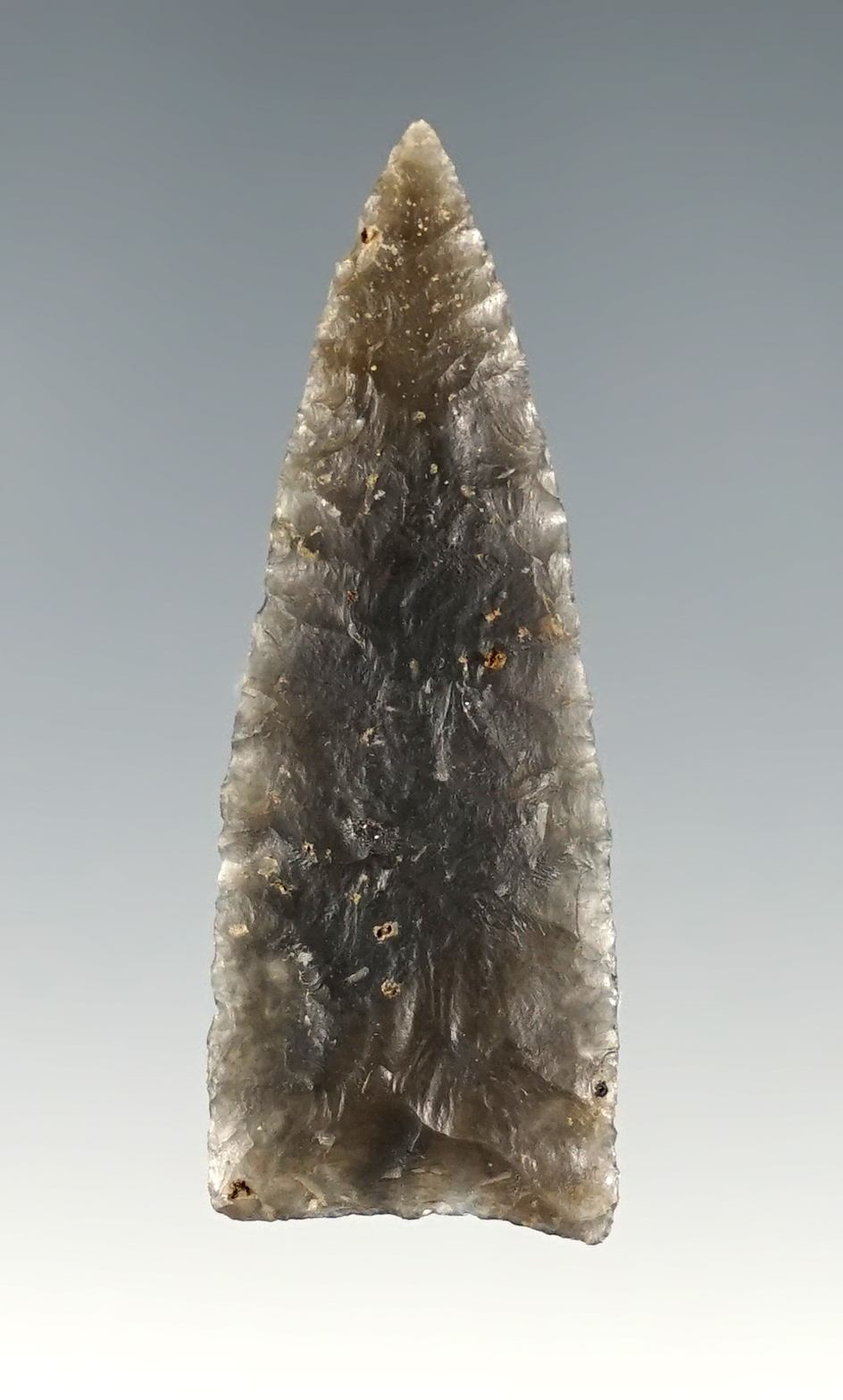 Thin and finely made 1 11/16" Kentucky Triangle point made from semi-translucent flint.