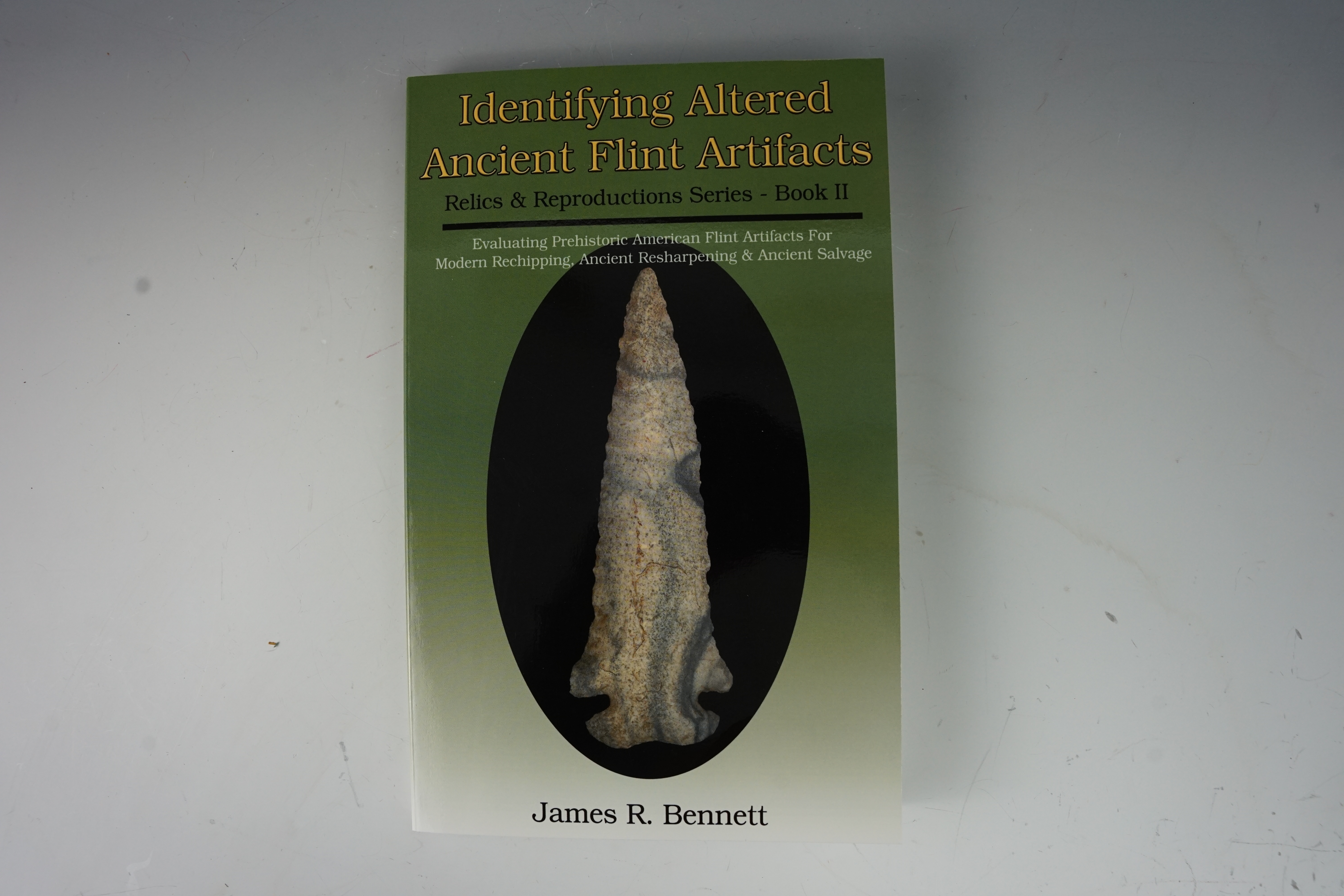 Softcover book "Identifying Altered Ancient Flint Artifacts" by James Bennett in new condition.