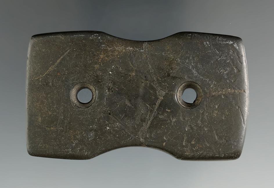 2 5/8" Hopewell Reel Gorget made from black Slate, broken and reglued. Found in  Logan Co., Ohio.