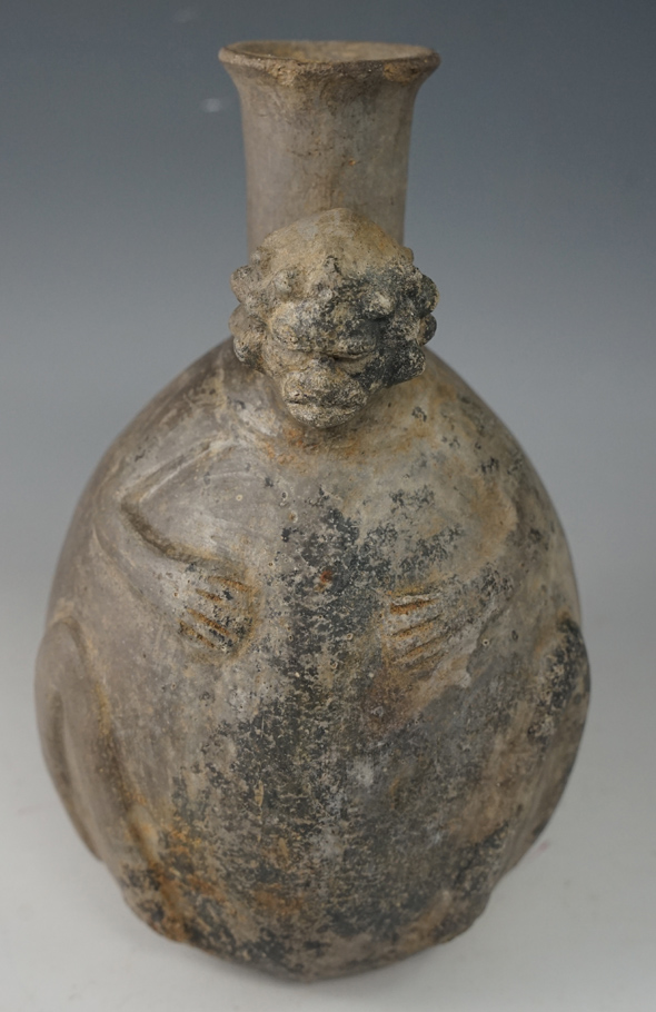 7 3/8" Tall Chimu culture "Roman head" design effigy strap handle pottery vessel. Found in Peru.