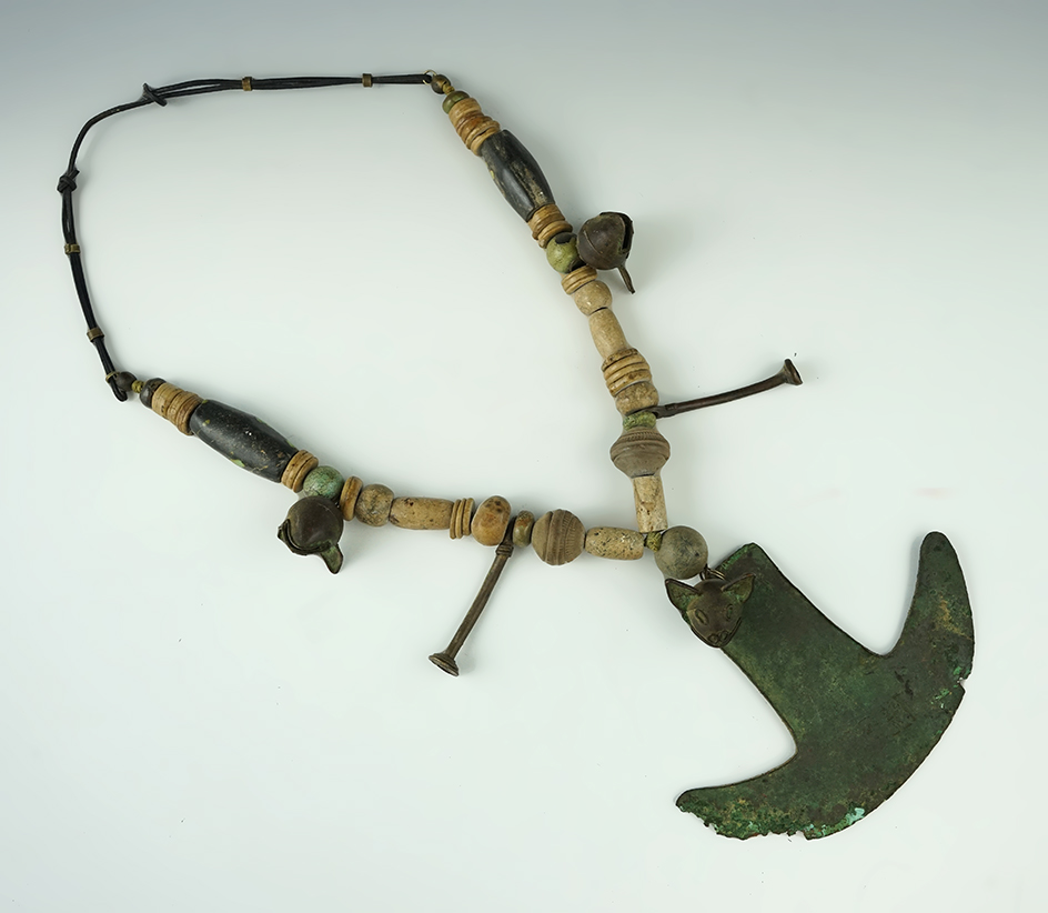 Set of strung pre-Columbian artifacts including stone beads, copper Tumi, and copper bells.