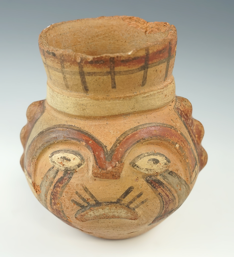 4 3/4" tall Wari pottery vessel with some wear to rim. Nice polychrome painted exterior. Peru.