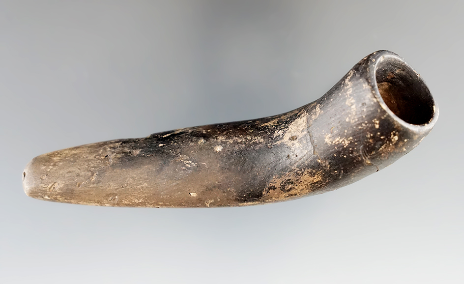 4 3/4" Mississippian clay pipe in nice condition. Some surface cracks, no missing pieces.