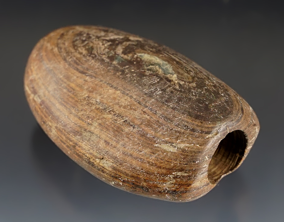 Well patinated 2 3/8" Bannerstone made from brown Banded Slate. Found in Paulding Co., Ohio. 